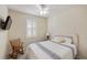 A nicely decorated bedroom boasts a ceiling fan and natural light at 2183 Nettlebush Ln, Venice, FL 34292