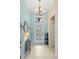 Inviting foyer with tiled flooring, decorative lighting, and stylish decor at 2183 Nettlebush Ln, Venice, FL 34292