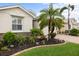Landscaped front yard with decorative plants, rock accents, and a well-manicured lawn at 2183 Nettlebush Ln, Venice, FL 34292