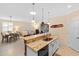 Open kitchen with granite countertops, modern appliances, and bar seating overlooking the living area at 2183 Nettlebush Ln, Venice, FL 34292