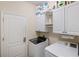 Laundry room featuring white washer, dryer and cabinets for storage at 2183 Nettlebush Ln, Venice, FL 34292