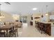 Open-concept living area with a kitchen, dining area, and comfortable seating at 2183 Nettlebush Ln, Venice, FL 34292