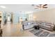 Open living area with tiled floors, comfortable seating, and ample natural light at 2183 Nettlebush Ln, Venice, FL 34292
