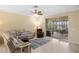 Open living room featuring a screened lanai overlooking a peaceful backyard view and comfortable seating at 2183 Nettlebush Ln, Venice, FL 34292