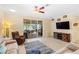 Relaxing living room featuring a sliding glass door to the lanai, a brown leather recliner and a ceiling fan at 2183 Nettlebush Ln, Venice, FL 34292