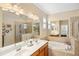 The bathroom features double sinks, tile flooring, and a garden tub at 2183 Nettlebush Ln, Venice, FL 34292