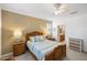 Comfortable main bedroom features stylish furniture, neutral carpet, and ceiling fan at 2183 Nettlebush Ln, Venice, FL 34292
