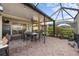Covered outdoor patio features brick pavers and a dining table with seating for eight at 2183 Nettlebush Ln, Venice, FL 34292
