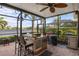Screened patio with wet bar, grill and seating area overlooking water at 2183 Nettlebush Ln, Venice, FL 34292