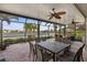 Screened in patio with a beautiful lake view and outdoor dining area at 2183 Nettlebush Ln, Venice, FL 34292