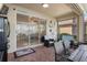 Covered patio with brick flooring and a view through sliding glass doors to the home's interior at 2183 Nettlebush Ln, Venice, FL 34292