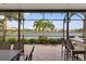 Screened patio features a waterfront view and an outdoor dining area with a wet bar at 2183 Nettlebush Ln, Venice, FL 34292