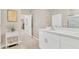 Neutral bathroom with a vanity and sink, complemented by decorative touches and an open doorway to the bedroom at 2756 Canoe Ln, North Port, FL 34286