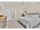Bright bedroom with a queen-size bed, complemented by an ensuite bathroom and neutral decor at 2756 Canoe Ln, North Port, FL 34286