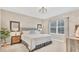 Comfortable bedroom featuring a queen-size bed, stylish lighting, and a calming, neutral color palette at 2756 Canoe Ln, North Port, FL 34286