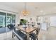 Dining area featuring modern lighting fixture and sliding door to the screened in patio at 2756 Canoe Ln, North Port, FL 34286