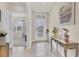 Inviting entryway with neutral tile flooring, complemented by a decorative table and artwork at 2756 Canoe Ln, North Port, FL 34286