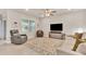Bright living room with tile floors, lots of natural light, comfortable seating and ceiling fan at 2756 Canoe Ln, North Port, FL 34286