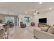 Open living space with neutral tile flooring, ceiling fan, and comfortable seating at 2756 Canoe Ln, North Port, FL 34286