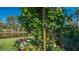 View of the backyard pond with lush vegetation and a well-maintained lawn at 315 Londonderry Dr, Sarasota, FL 34240