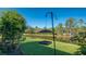 Scenic backyard view featuring a bird feeder, lush lawn, and tranquil pond at 315 Londonderry Dr, Sarasota, FL 34240