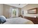 Bedroom with a shuttered window, dresser, and neutral walls that let the natural light shine through at 315 Londonderry Dr, Sarasota, FL 34240