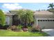 Beautiful home featuring a well-manicured lawn and colorful flower beds enhancing curb appeal at 315 Londonderry Dr, Sarasota, FL 34240