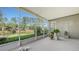 Tranquil screened lanai featuring scenic pond views and lush landscaping at 315 Londonderry Dr, Sarasota, FL 34240