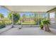 Spacious screened lanai with serene pond views and lush tropical landscaping at 315 Londonderry Dr, Sarasota, FL 34240