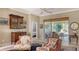 Bright living room showcasing stylish decor, built-in cabinetry, and access to a screened lanai with pond views at 315 Londonderry Dr, Sarasota, FL 34240
