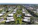 Aerial view of a vibrant community with manicured lawns, inviting pools, and well-maintained houses at 3259 Fairhaven Ln # 211, Sarasota, FL 34239