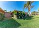 Inviting backyard features tropical landscaping and a well-maintained lawn on a sunny day at 3259 Fairhaven Ln # 211, Sarasota, FL 34239