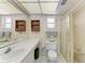 This bathroom has a mirrored wall, enclosed shower, and open shelving at 3259 Fairhaven Ln # 211, Sarasota, FL 34239