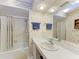 Cozy bathroom with floral wallpaper, mirrored wall, and tub with shower at 3259 Fairhaven Ln # 211, Sarasota, FL 34239