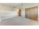 Empty bedroom with neutral carpet, ceiling fan, and closet at 3259 Fairhaven Ln # 211, Sarasota, FL 34239