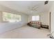 A bright bedroom features neutral walls and carpet, complemented by a ceiling fan and natural light at 3259 Fairhaven Ln # 211, Sarasota, FL 34239