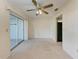 Spacious bedroom with ceiling fan and sliding glass door to the outdoor space at 3259 Fairhaven Ln # 211, Sarasota, FL 34239