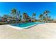 Relaxing community pool is surrounded by swaying palms, offering a refreshing oasis and a tropical vibe at 3259 Fairhaven Ln # 211, Sarasota, FL 34239