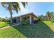 Charming home exterior featuring a screened patio and lush green landscaping. The property is well maintained at 3259 Fairhaven Ln # 211, Sarasota, FL 34239