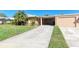 Charming single-story home featuring a driveway, carport, and attached garage at 3259 Fairhaven Ln # 211, Sarasota, FL 34239