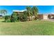 Well-manicured lawn and lush tropical landscaping enhance this home's curb appeal at 3259 Fairhaven Ln # 211, Sarasota, FL 34239