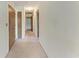 Hallway with carpet, neutral-colored doors, and painted white walls at 3259 Fairhaven Ln # 211, Sarasota, FL 34239