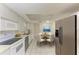 An eat-in kitchen features stainless steel appliances and room for a table and chairs at 3259 Fairhaven Ln # 211, Sarasota, FL 34239
