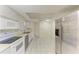 The kitchen features stainless steel appliances and white cabinetry at 3259 Fairhaven Ln # 211, Sarasota, FL 34239