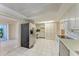 A kitchen with white cabinets, stainless steel appliances, and tile floors at 3259 Fairhaven Ln # 211, Sarasota, FL 34239