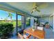 Enclosed lanai features tile flooring, ceiling fans, and large glass windows showcasing the community landscaping at 3259 Fairhaven Ln # 211, Sarasota, FL 34239