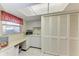 The laundry room features white cabinets and a folding table at 3259 Fairhaven Ln # 211, Sarasota, FL 34239