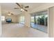 The carpeted living room features two ceiling fans and glass doors to an enclosed porch at 3259 Fairhaven Ln # 211, Sarasota, FL 34239