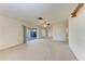 Empty living room boasts a sliding glass door that opens onto the lanai, offering views of the community landscape at 3259 Fairhaven Ln # 211, Sarasota, FL 34239