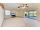 Empty living room boasts a sliding glass door that opens onto the lanai, offering views of the community landscape at 3259 Fairhaven Ln # 211, Sarasota, FL 34239